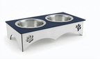 A double pet feeder and waterer stand with a dark navy blue top and a silver metal base, featuring two stainless steel bowls and decorative paw print cutouts on the sides.