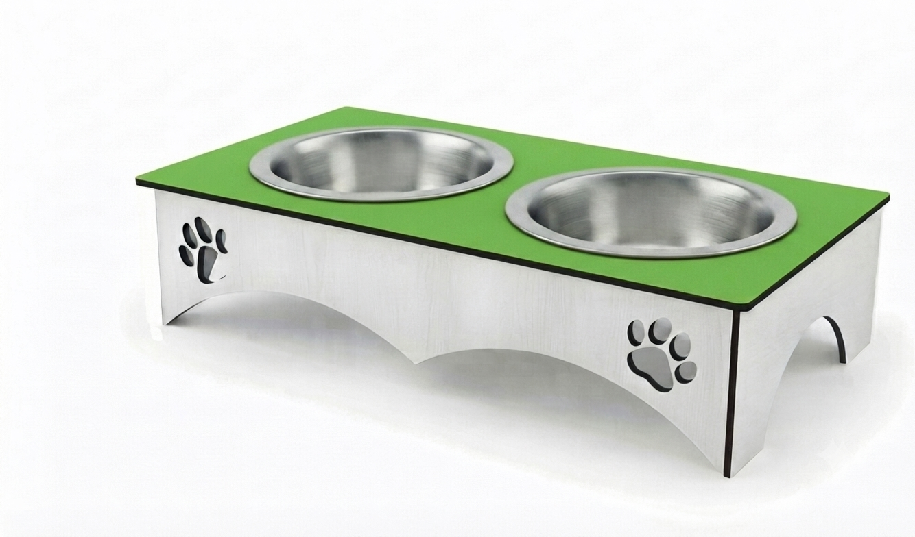 A stainless steel elevated pet feeder and water bowl stand with a bright green top surface, two integrated bowls, and paw print cutouts on the sides, shown on a white background.