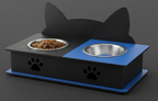 A black and blue elevated pet feeder and water bowl stand with cat-ear silhouette backrest, stainless steel bowls, and paw print cutouts on a dark gray background.