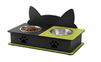 A black cat-shaped pet feeder and waterer with two bowls, one filled with dry food. The feeder features a lime green top panel and base, with a black paw print cutout on the front.