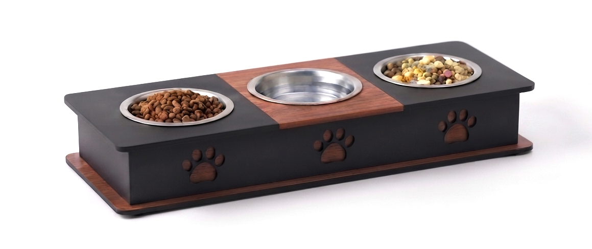 A black and brown elevated pet feeder with three bowls, including two filled with pet food, shown on a white background.