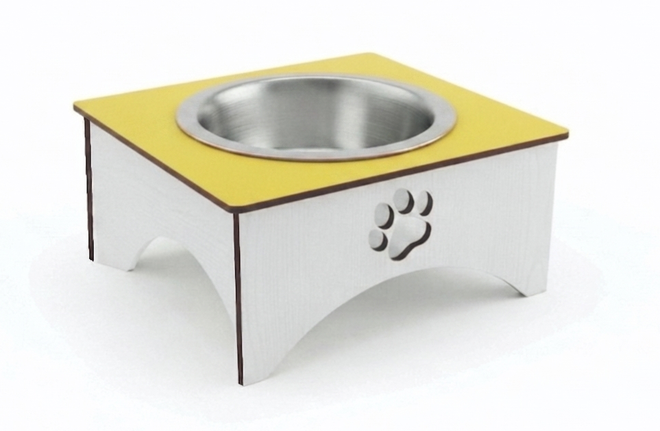 A square elevated pet food bowl stand with a yellow top surface, a stainless steel bowl, and a white base featuring a paw print cutout, shown on a white background.