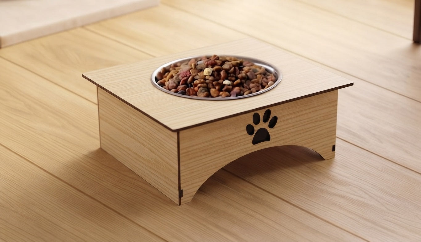 A wooden elevated pet feeder with a stainless steel bowl filled with kibble, placed on a light wood floor. The feeder has a black paw print logo on the front.