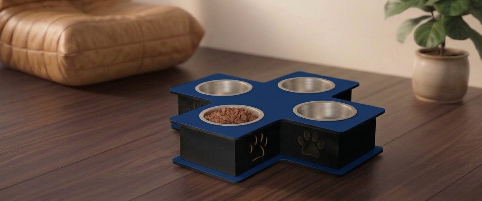A four-bowl elevated pet feeder and waterer with a blue top and black base, featuring a paw print design on the front, set on a dark wood floor.