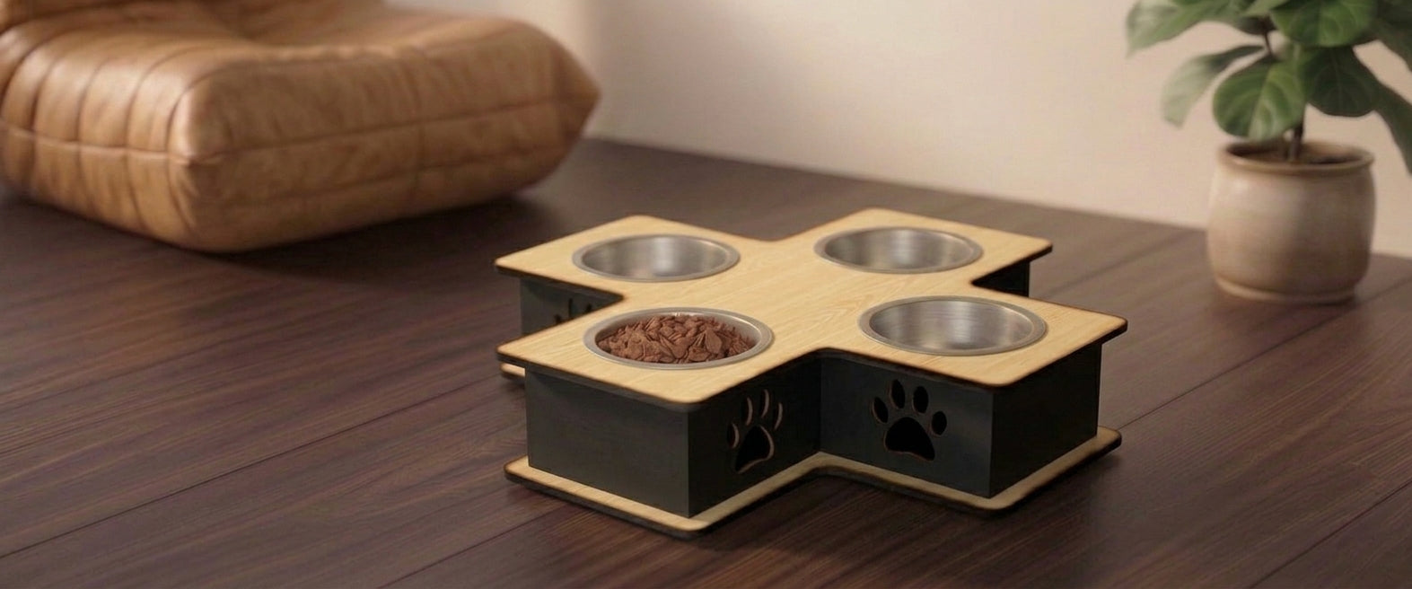 A wooden elevated pet feeder with four stainless steel bowls, one filled with kibble, placed on a dark wood table in a home setting.