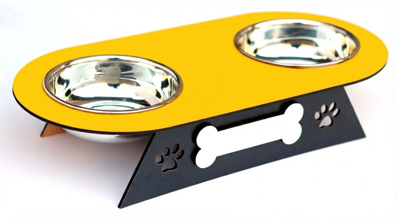A two-bowl pet feeder and waterer stand with a bright yellow top plate, stainless steel bowls, and a black metal base featuring a bone-shaped cutout and paw print details.
