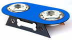 A pet double bowl feeder with a bright blue top tray, two stainless steel bowls, and a black metal stand featuring a bone-shaped center and paw print cutouts.