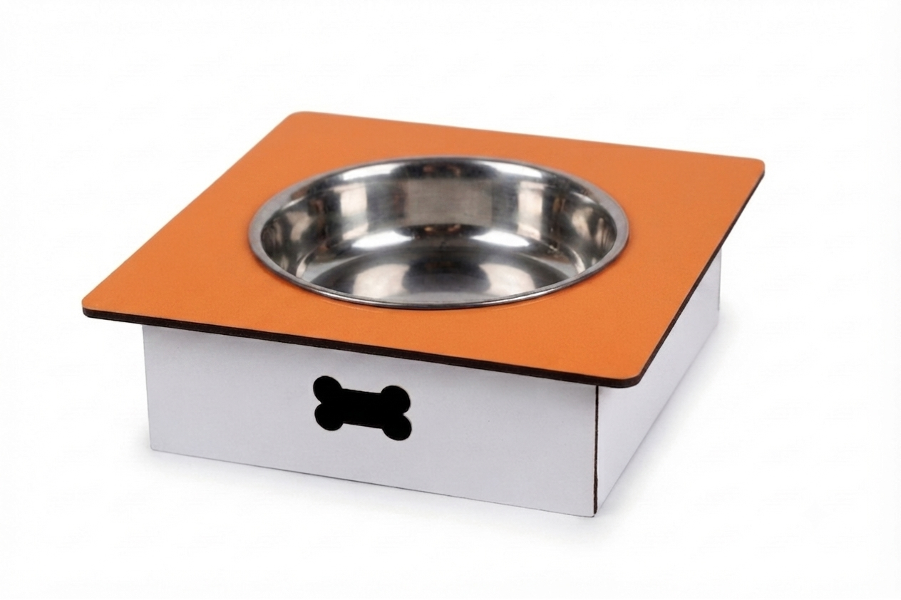A square dog feeder and waterer stand with a stainless steel bowl set into an orange top surface, mounted on a white base with a black bone-shaped cutout, shown on a white background.