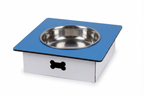 A square elevated pet feeder and water bowl stand with a blue top platform, a stainless steel bowl, and a white base featuring a black bone-shaped handle, shown on a white background.