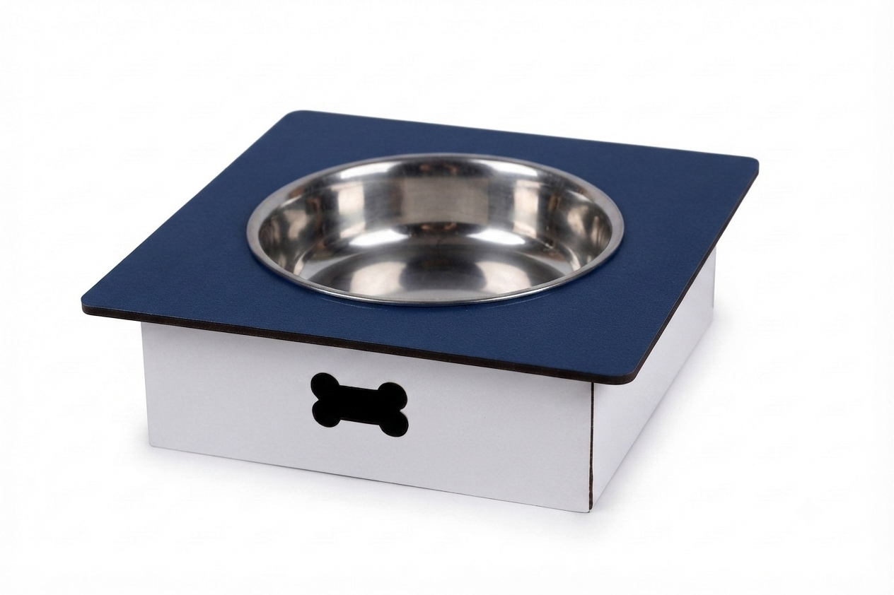 A square pet feeder or elevated bowl stand with a stainless steel bowl on a dark blue top surface and a white base, featuring a black bone-shaped cutout on the front, shown on a white background.