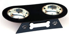 A black elevated pet feeder and waterer with two stainless steel bowls, featuring a decorative stand with paw prints and a bone-shaped cutout on a white background.