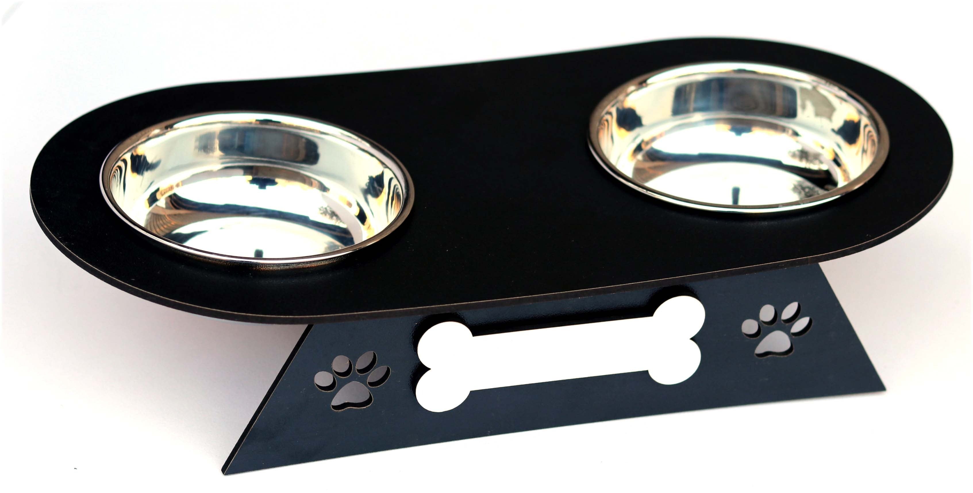 A black elevated pet feeder and waterer with two stainless steel bowls, featuring a decorative stand with paw prints and a bone-shaped cutout on a white background.