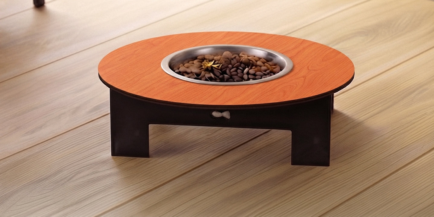 A low round elevated pet feeder table with a warm orange-brown wood-grain top, a dark brown base, and a stainless steel bowl filled with pet food, set on a light wood plank floor.