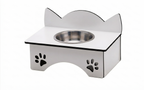 A stainless steel elevated pet feeder and water bowl stand with a cat-ear-shaped backrest and paw print cutouts on the front, shown on a white background.