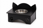 A black metal elevated pet feeder with cat-ear shaped backrest and paw print cutouts on the sides, featuring a stainless steel bowl, shown on a white background.