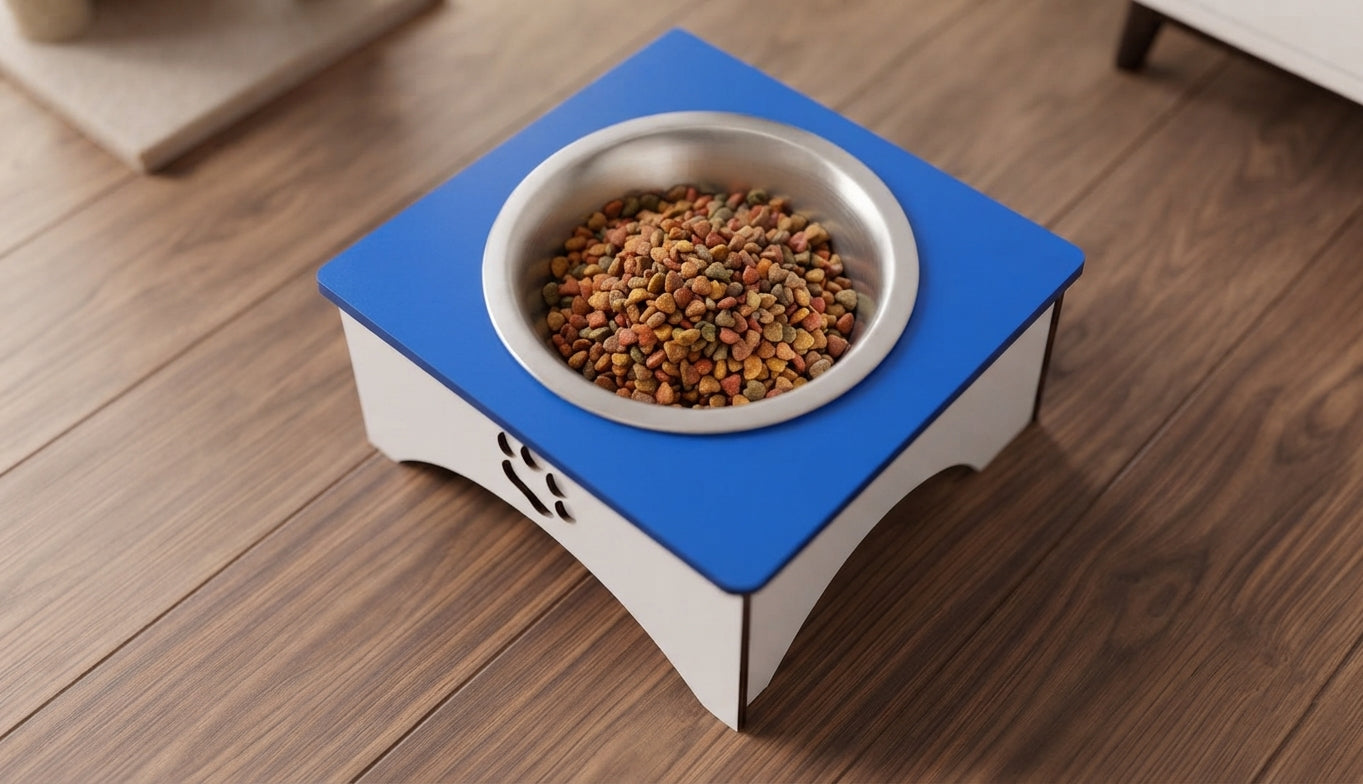 A raised pet feeder stand with a blue top and white base, holding a stainless steel bowl filled with dry kibble, placed on a wooden floor.