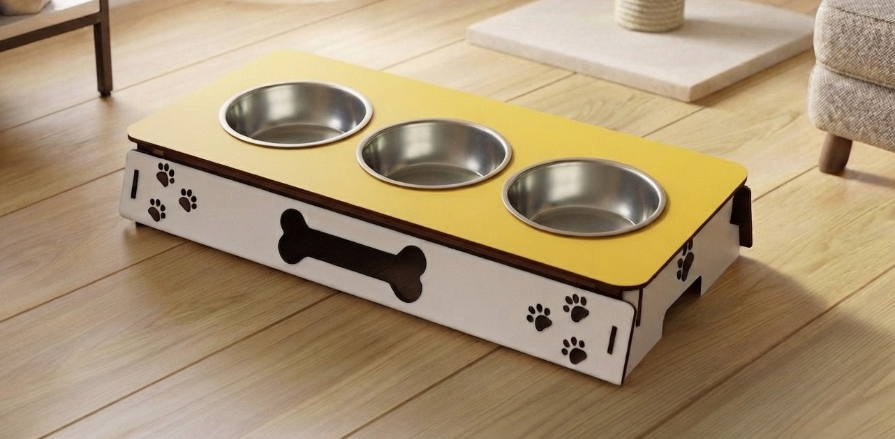 A pet elevated feeding station with three stainless steel bowls on a yellow and white wooden base, shown on a light wood floor in a home setting.