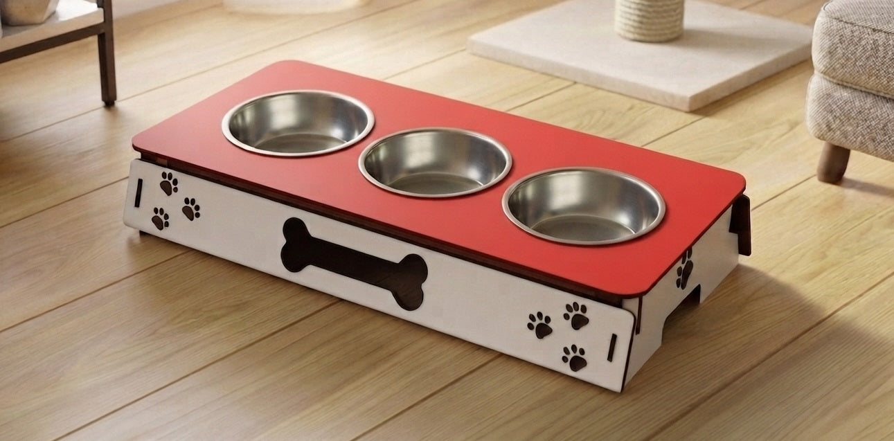 A raised pet feeder and water bowl stand with three stainless steel bowls on a red top, set on a light wood floor in a home environment.